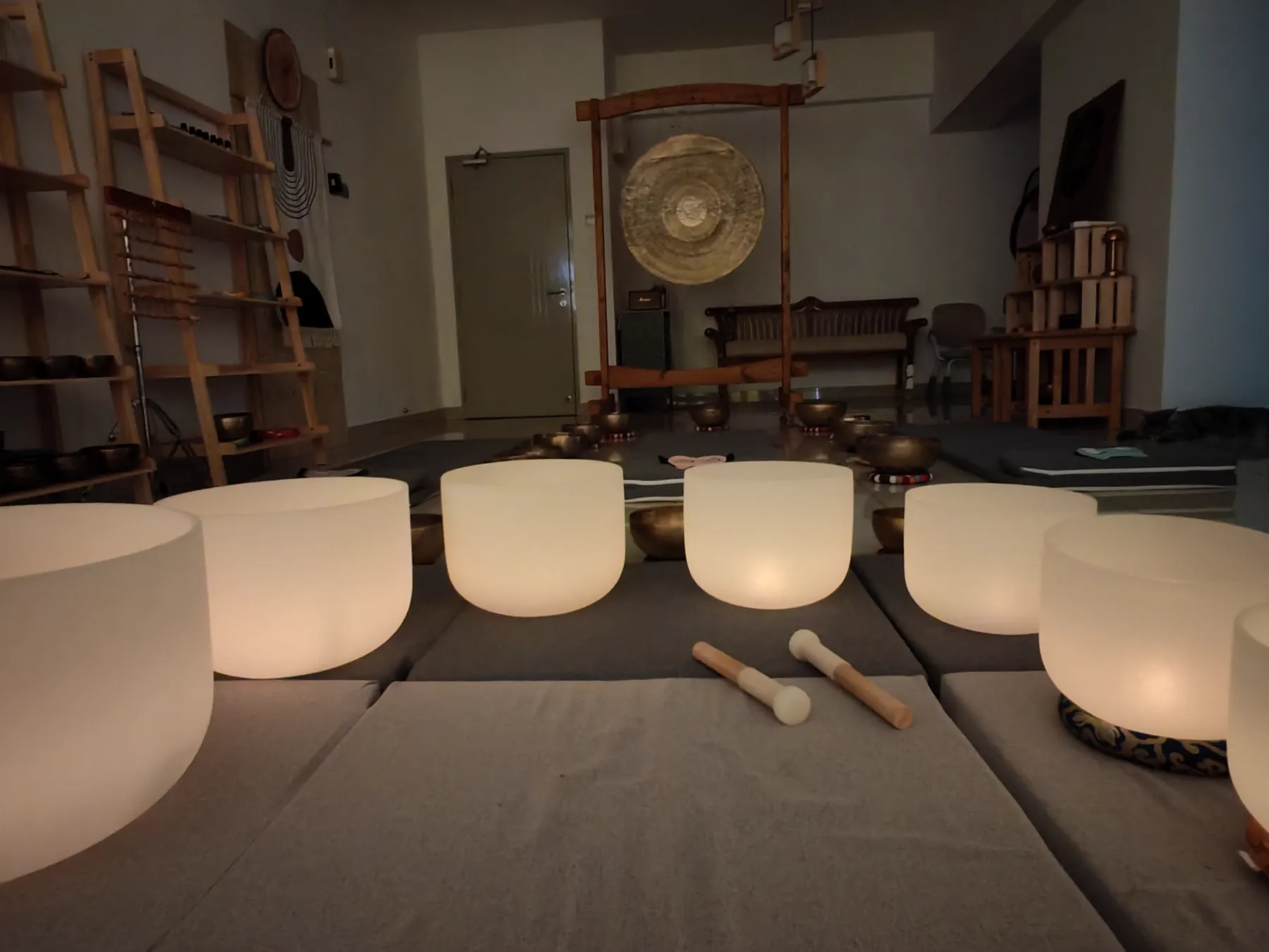 ZUDEN group sound healing setup with singing bowls and gong